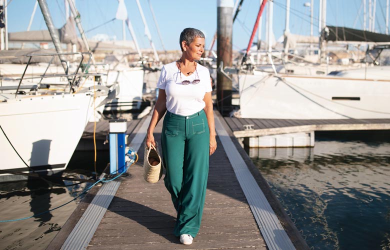 older woman walking on pier