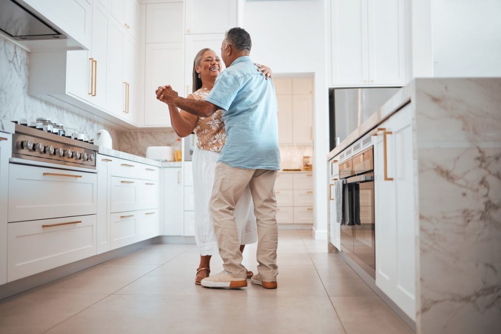 older couple dancing in kitchen