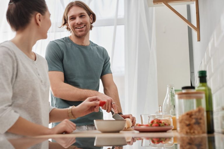 young man and woman cooking